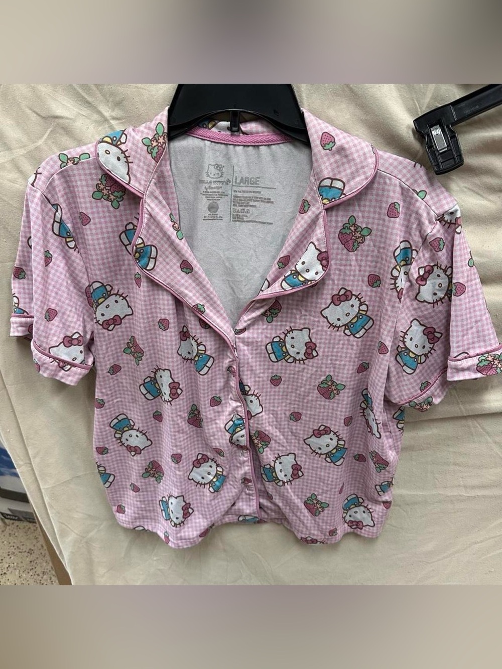 Light pink hello kitty and strawberry pajama top.